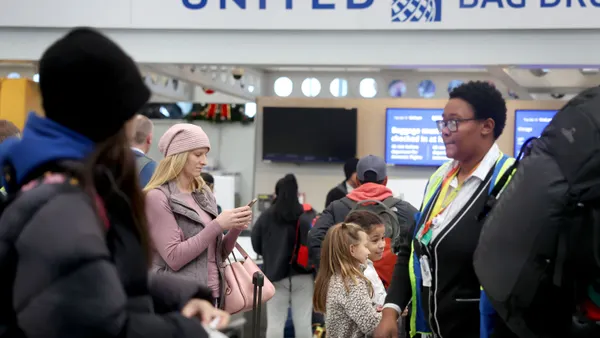 Travelers check in at the airport.