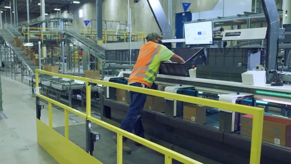A Walmart associate handling boxes.