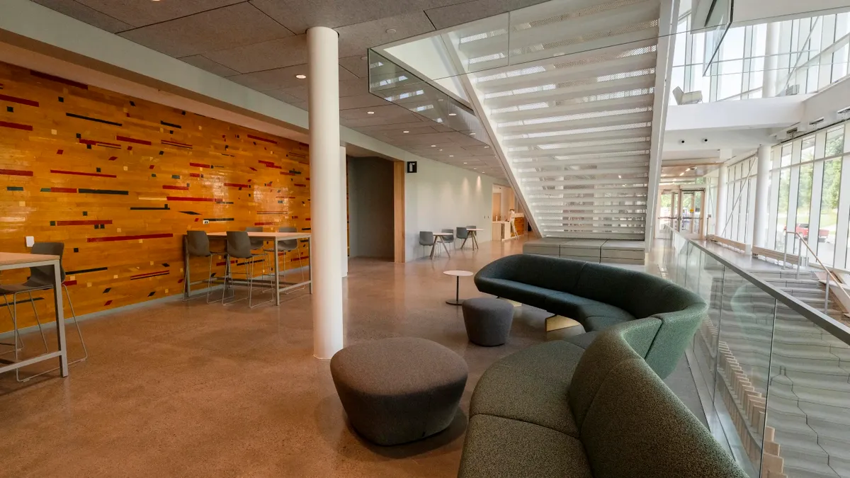 The second floor of the Highmark Center for Health, Wellness and Athletics, with lounging sofas and desks in the foreground.