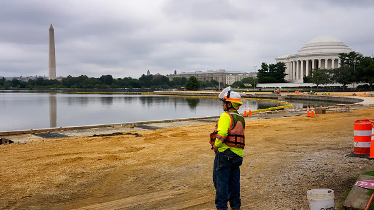 A construction worker wears high-vis safety gear on a jobsite.