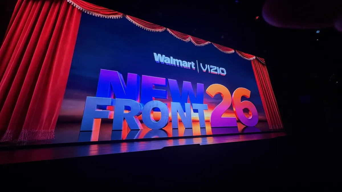 Walmart and Vizio logos sit on a stage in New York