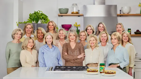 Martha Stewart stands behind a counter surrounded by look-alikes.