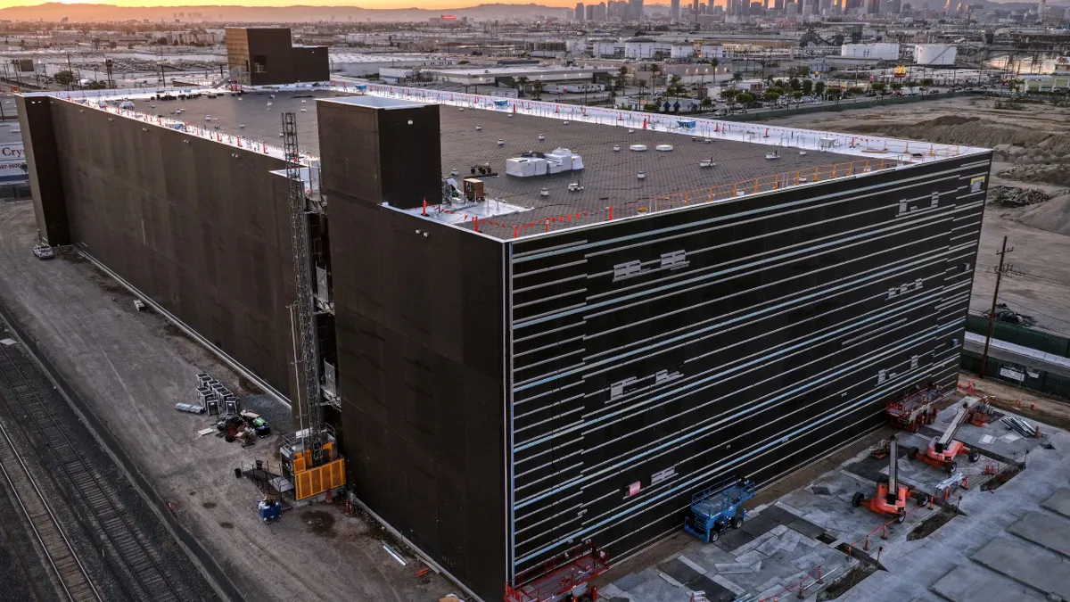 An aerial view of a three-level building under construction