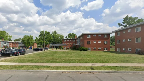 A low-rise apartment property on a sunny day.