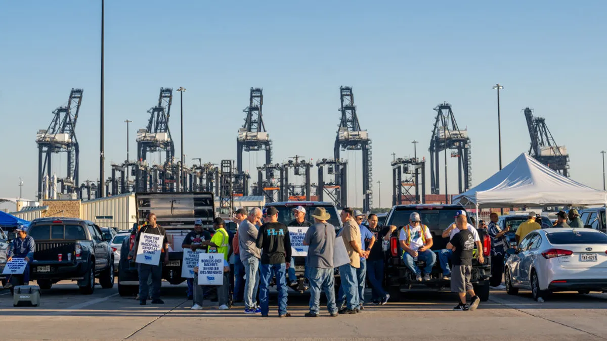 Dockworkers strike outside an ocean container port.