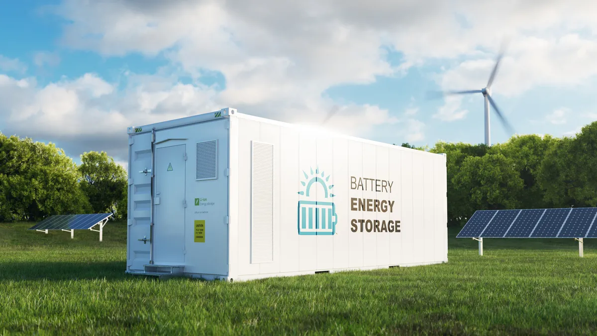 concept of a modern high-capacity battery energy storage system in a container located in the middle of a lush meadow with a forest in the background.