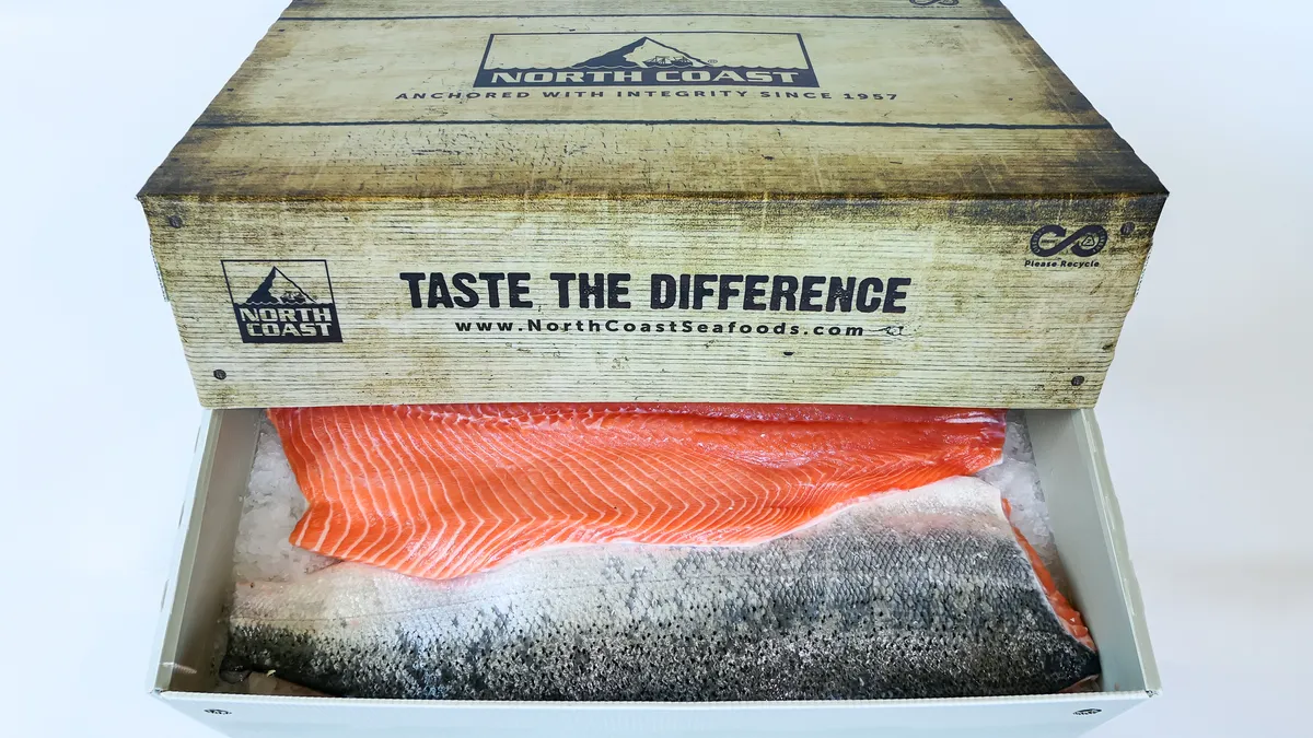 An open box containing salmon; wording on box says 'TASTE THE DIFFERENCE' 'www.NorthCoastSeafoods.com'