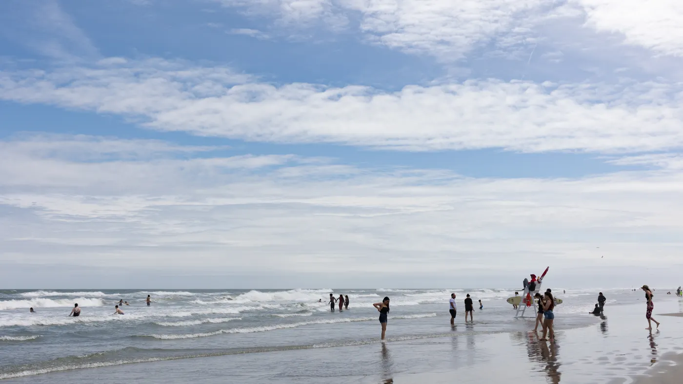 A group of people swim and play at a beach as a lifeguard watches in Wildwood, New Jersey, during Memorial Day weekend in 2023.