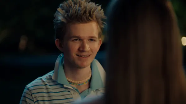 A teenager sporting spiked blond hair and dual popped collar polos stands on a doorstep in an Axe ad.