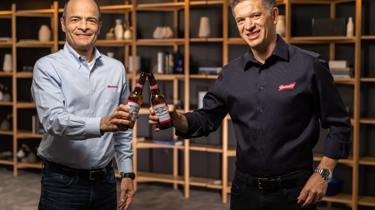 Michel Doukeris, right, will succeed Carlos Brito as CEO of AB InBev on July 1, 2021