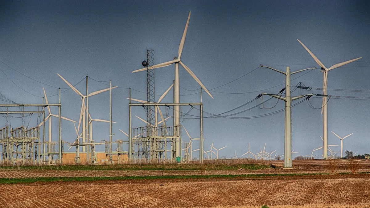 Wind turbines in McLean County, Illinois, with a substation and high voltage transmission wires.