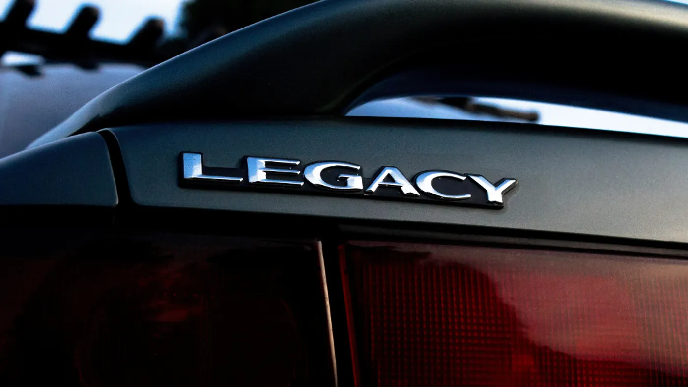 Chrome “LEGACY” badge on Subaru trunk.