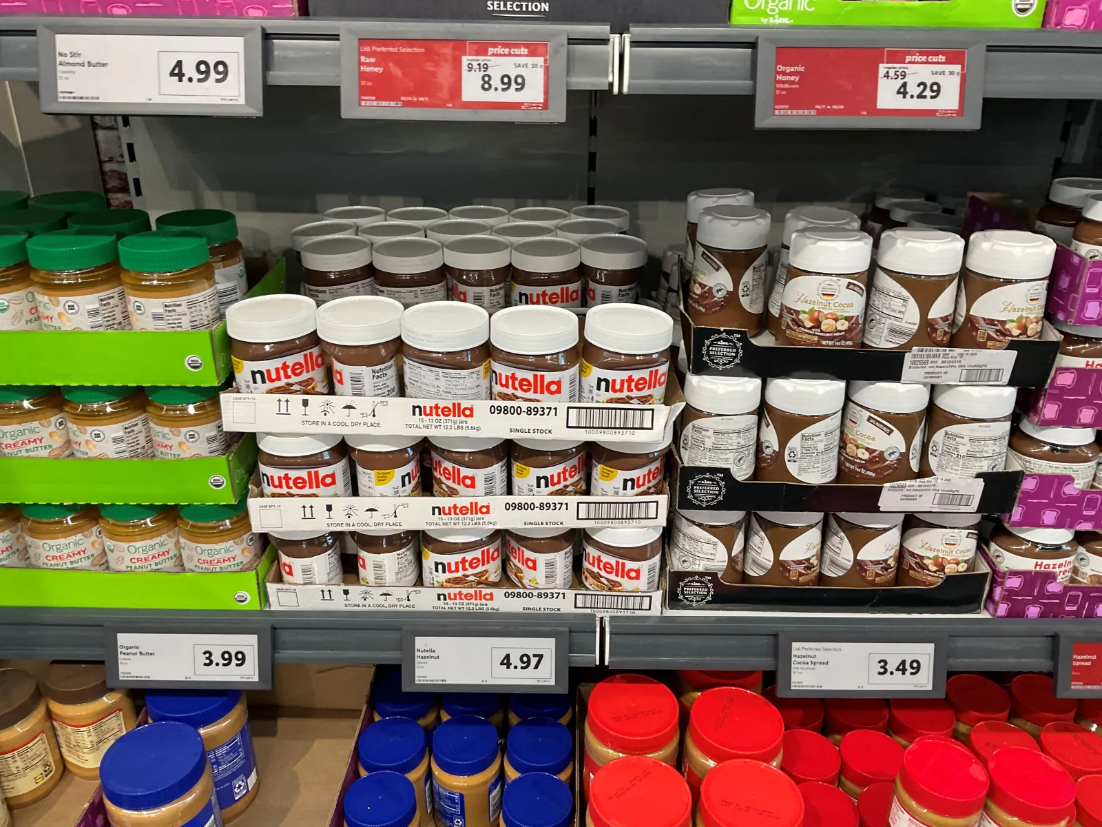 Jars of hazelnut spread on a store shelf.
