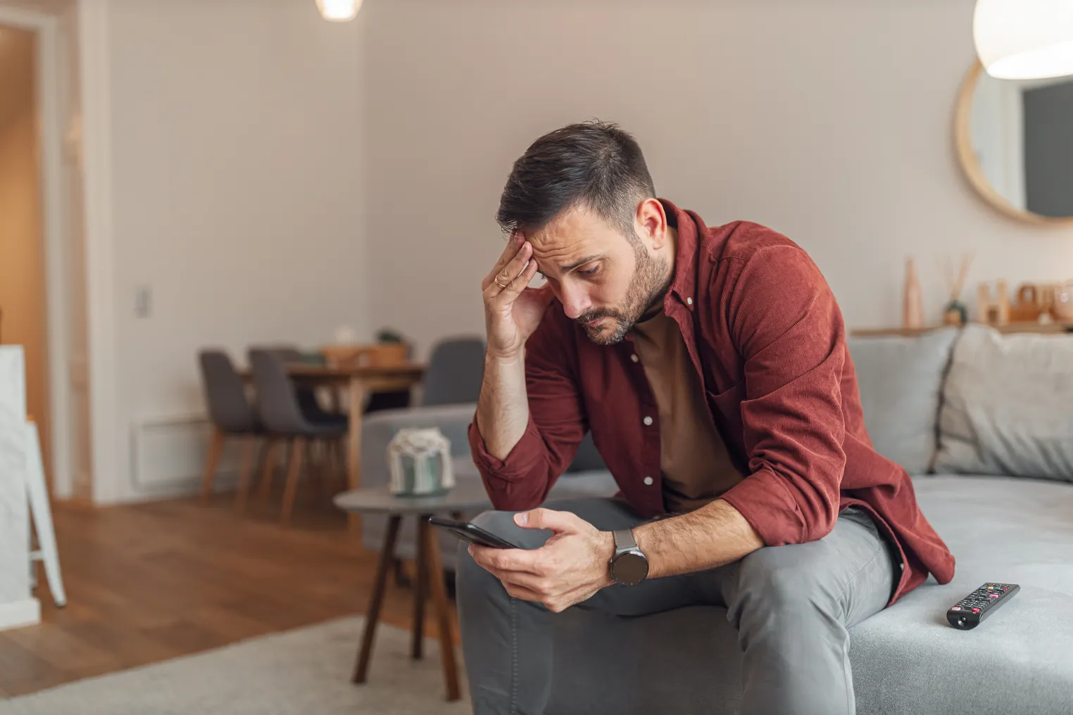 A man is stressed as he looks at his phone