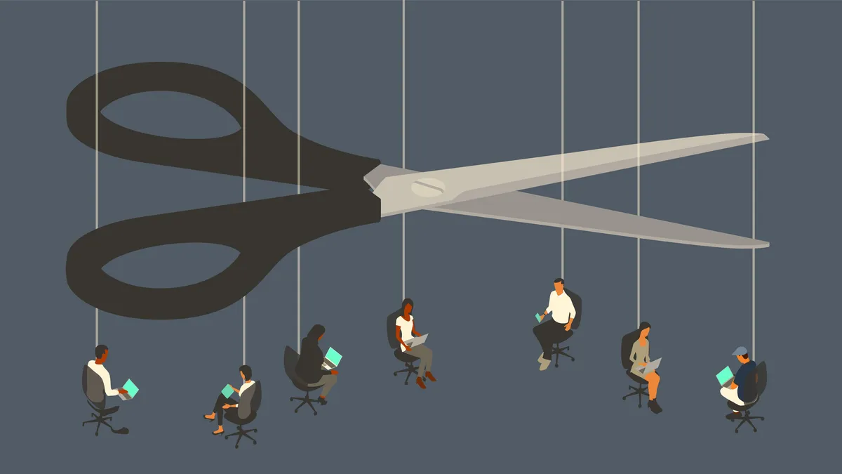 An oversized pair of scissors looms over seven workers sitting in office chairs suspended by strings.