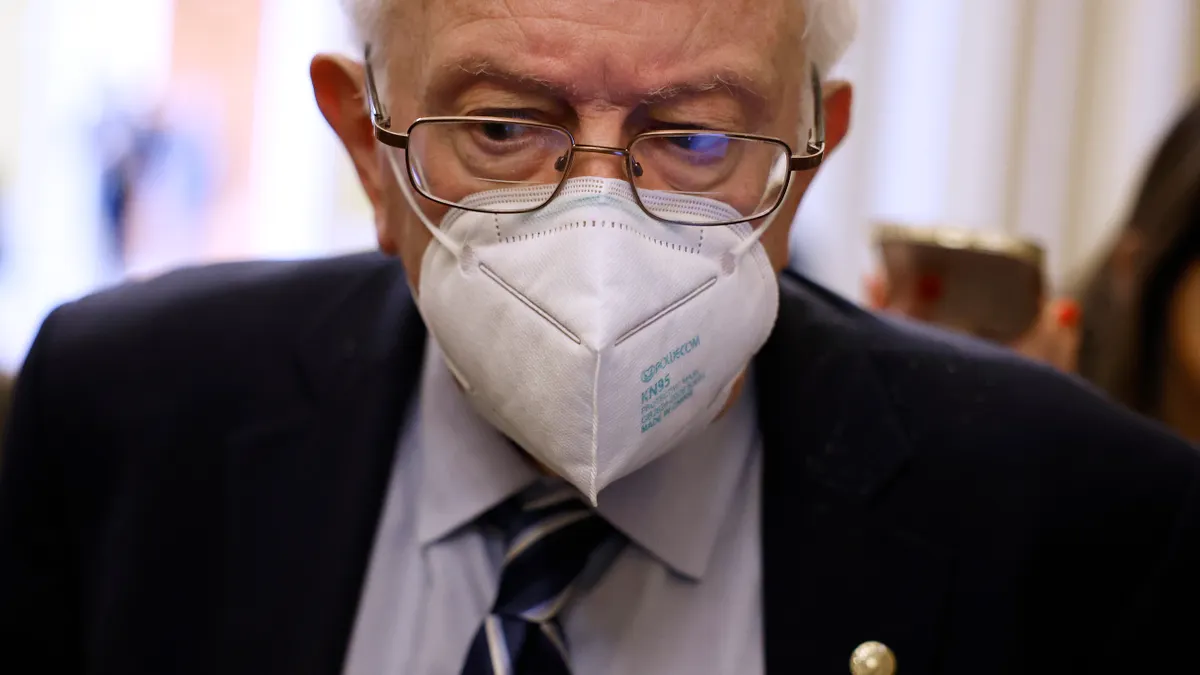 An up-close and above the shoulder picture of Senator Bernie Sanders wearing a medical face mask