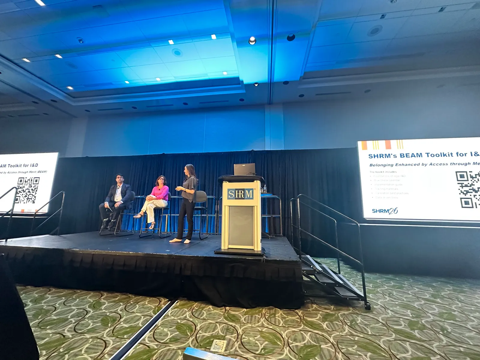 Three people talk on a stage at SHRM Annual Conference 2026.