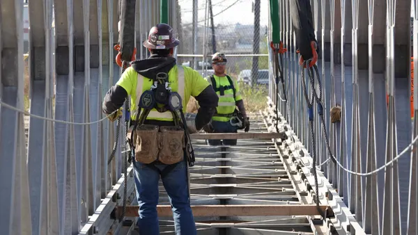 Workers install a temporary bridge along the east side of Tonelle Avenue in New York City.