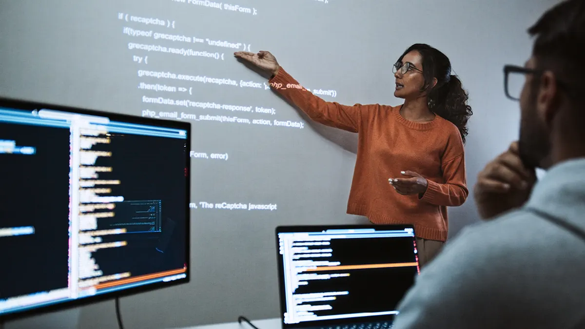 A person teaching students new digital skills in a class setting