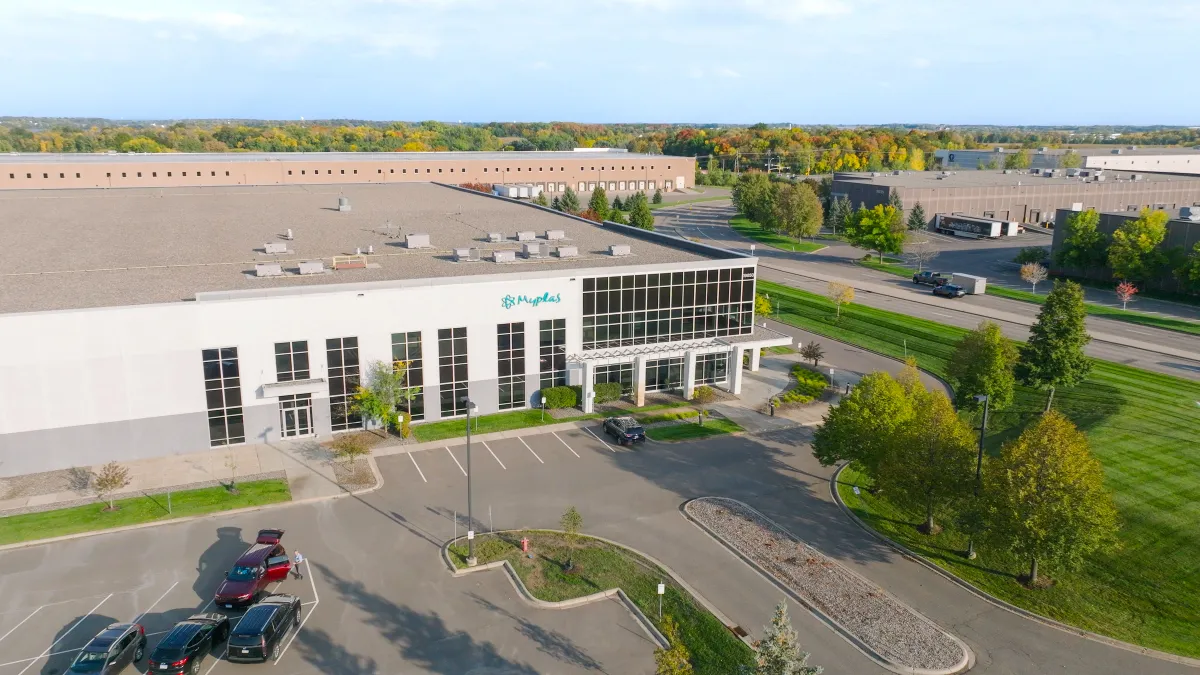 Wide shot of a building exterior with the "Myplas" logo.