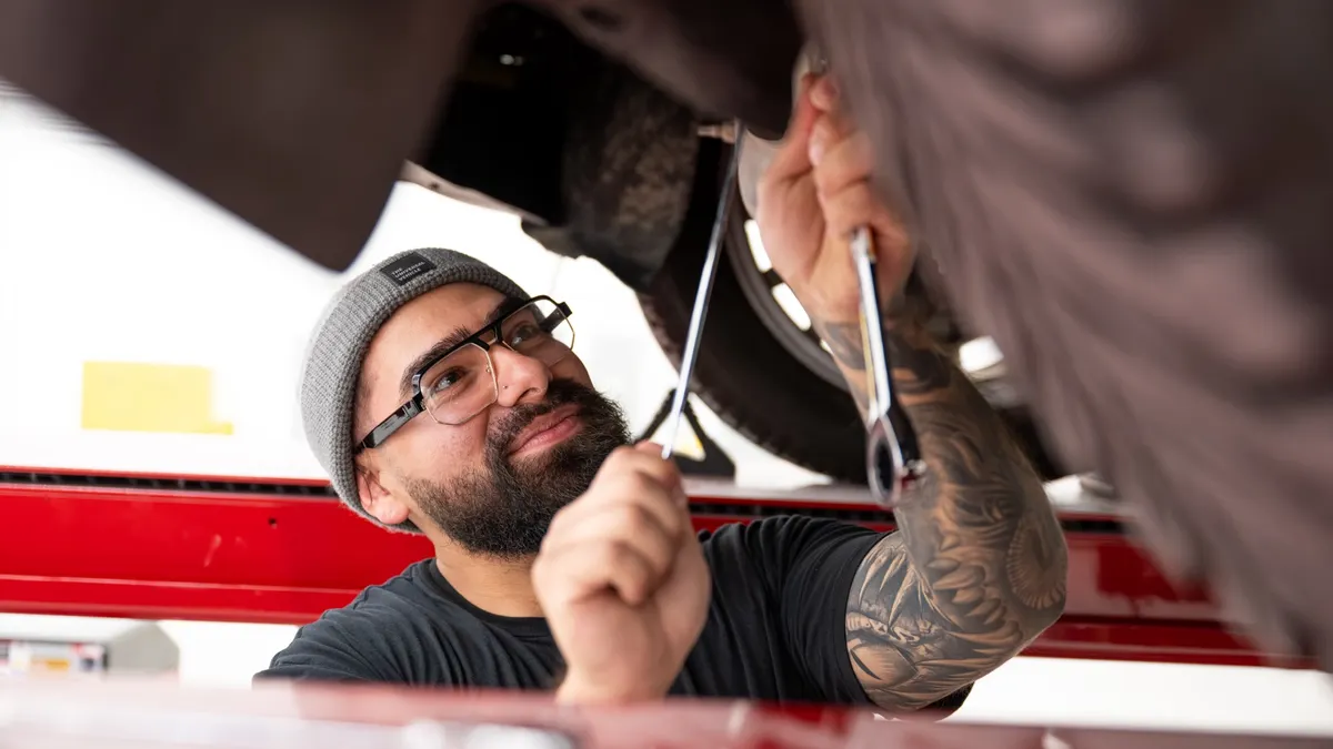 Under a vehicle at Ford's Electric Vehicle Development Center in Long Beach, California