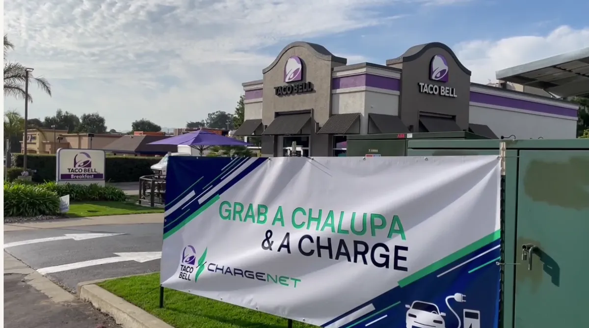 An image of a Taco Bell sign that says "grab a chalupa and a charge."