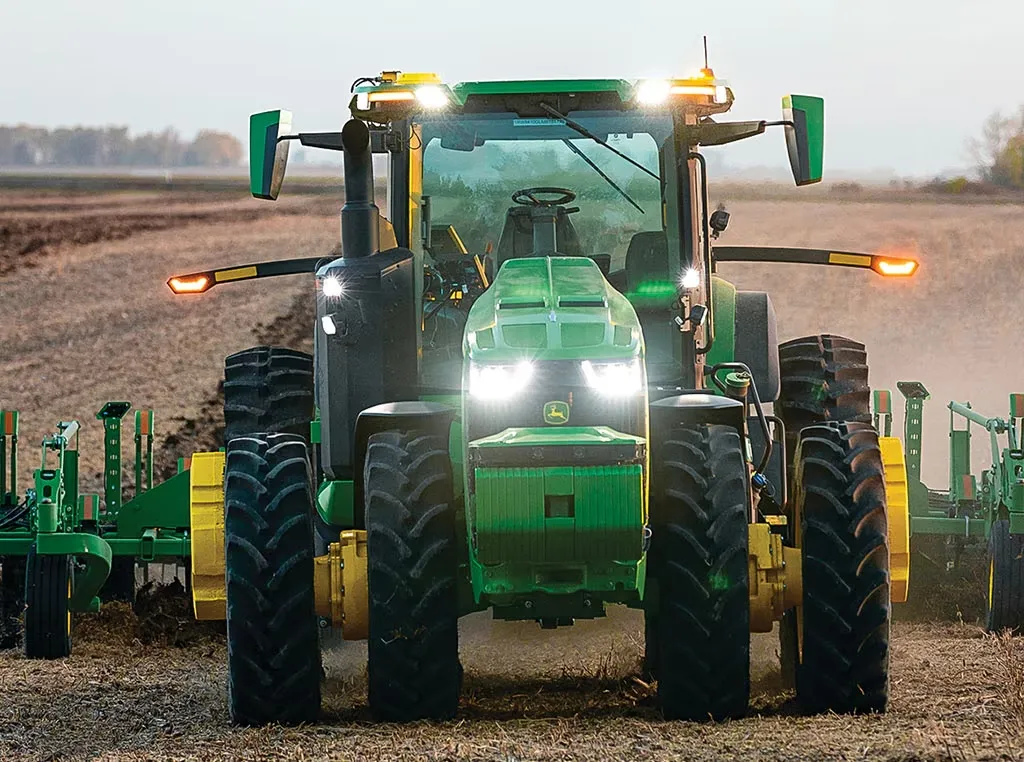 A Deere tractor is seen running without a person in the driver's seat