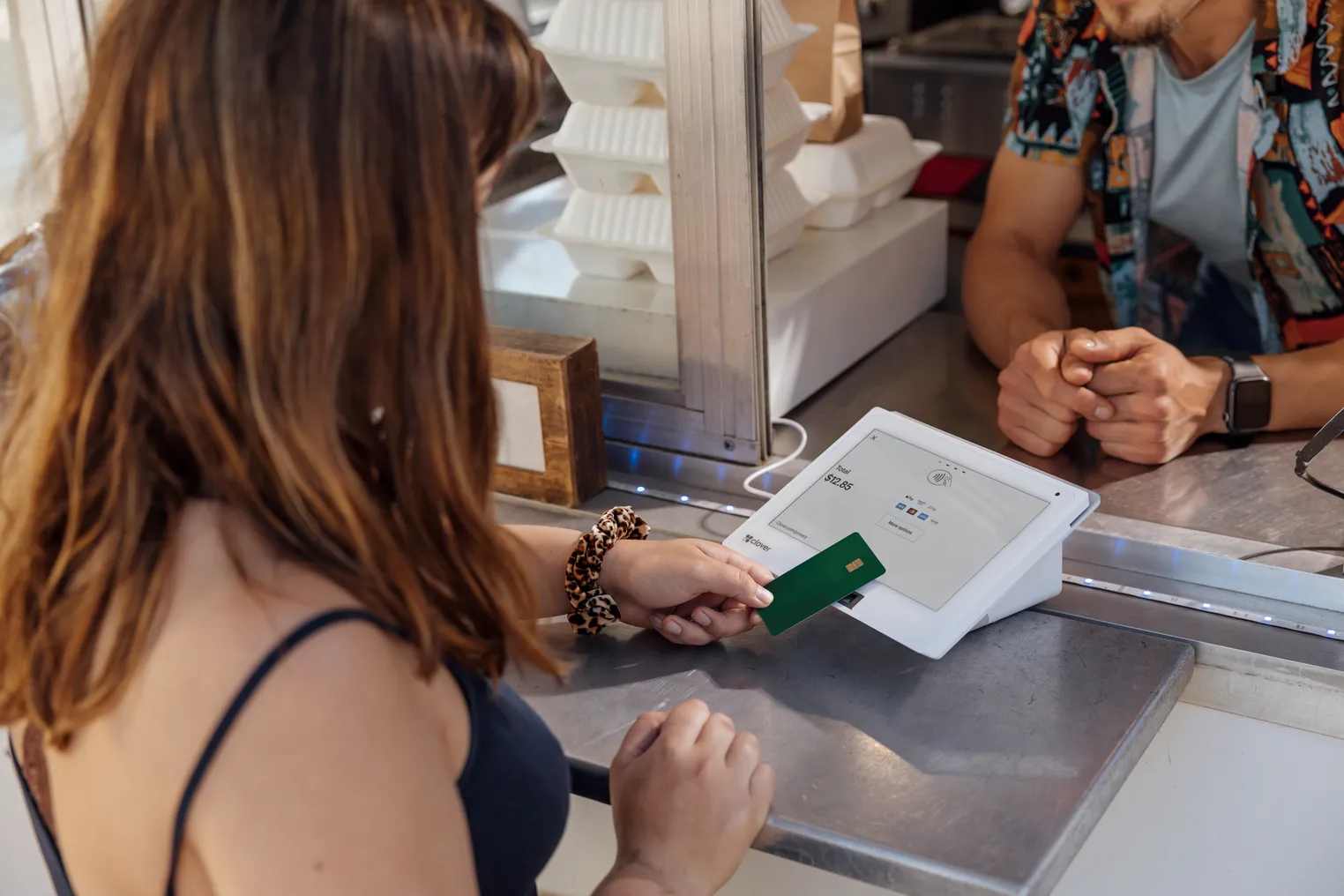 A customer pays using a Clover device