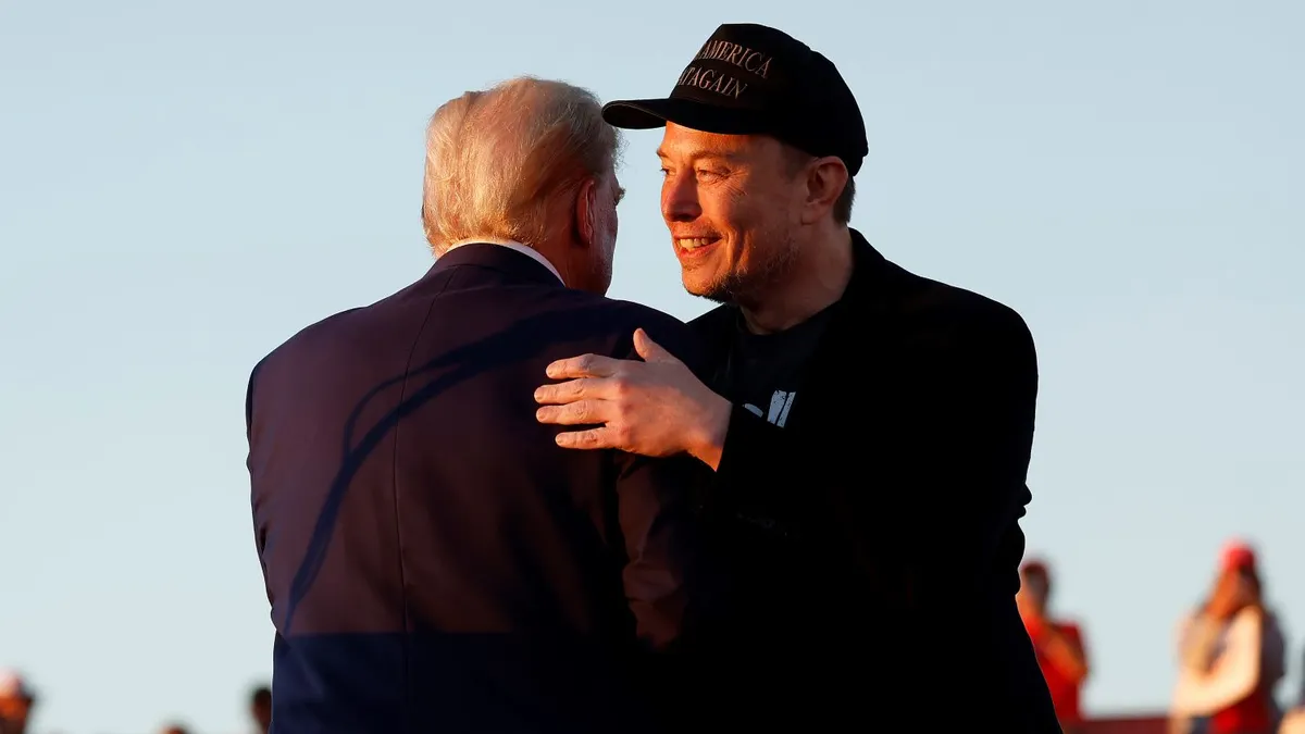 Elon Musk embraces Republican presidential nominee, former President Donald Trump during a campaign rally at the Butler Farm Show fairgrounds on October 05, 2024 in Butler, Pennsylvania.