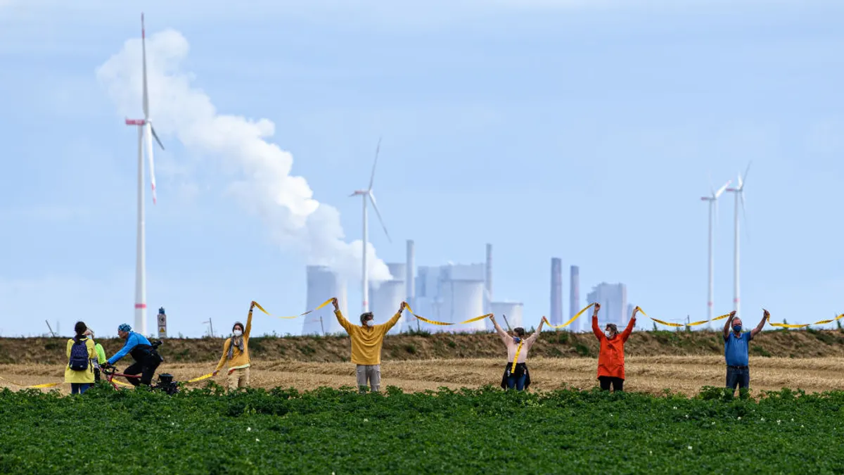 People seen protesting in front of a factory.