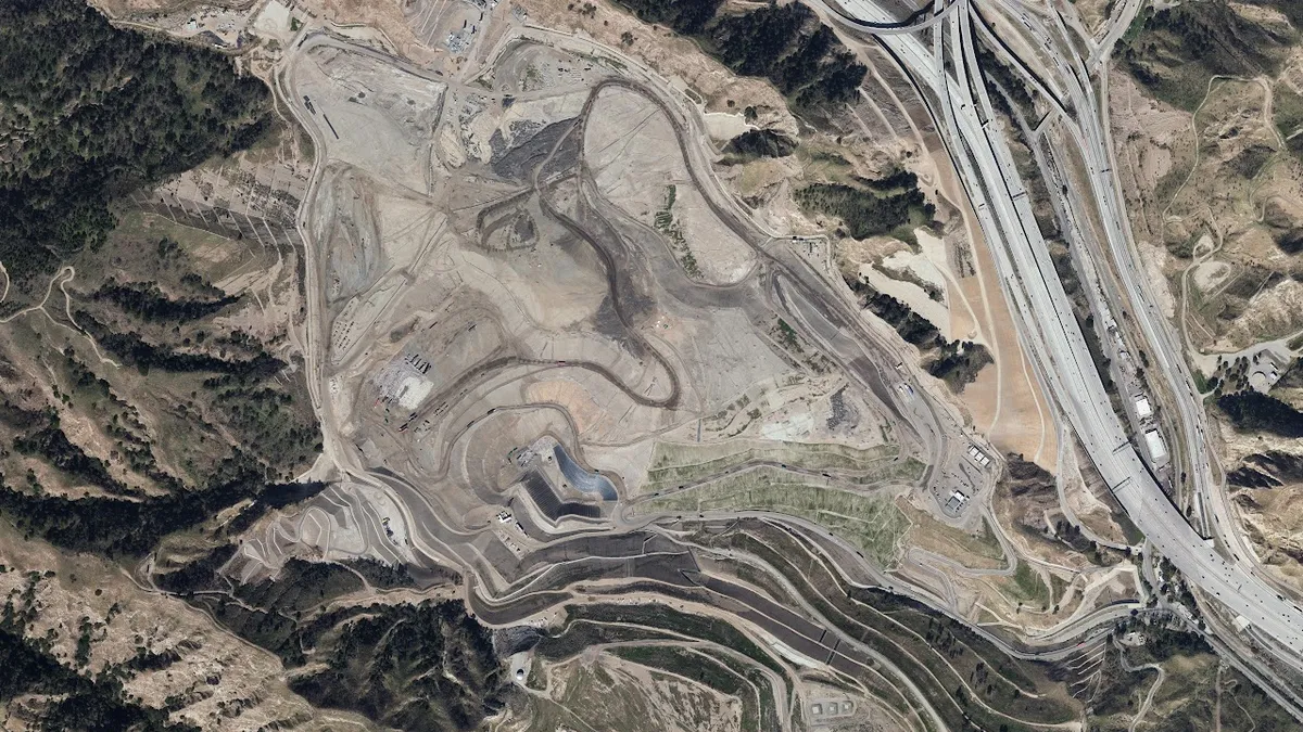 Overhead view of a landfill showing roads to the right and left of the facility