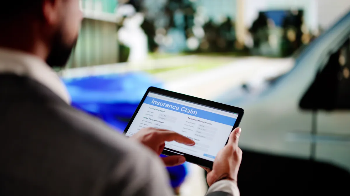Black Insurance Expert Evaluating Vehicle Damage After Car Accident Claim