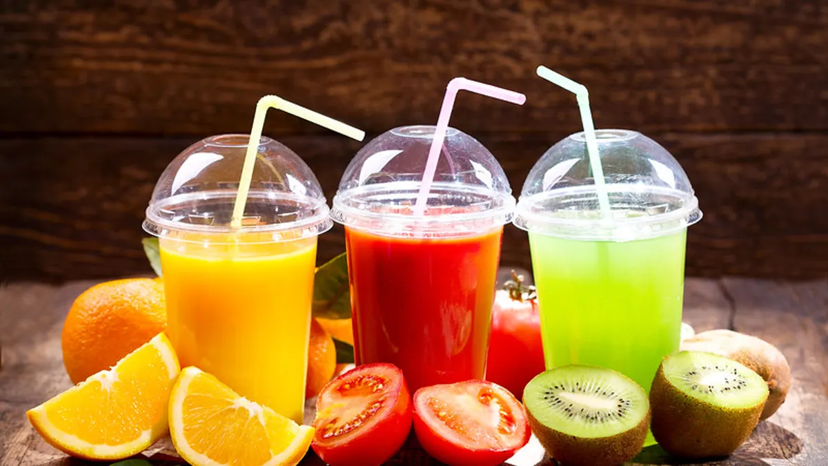 Fresh juices with fruits and vegetables on wooden background