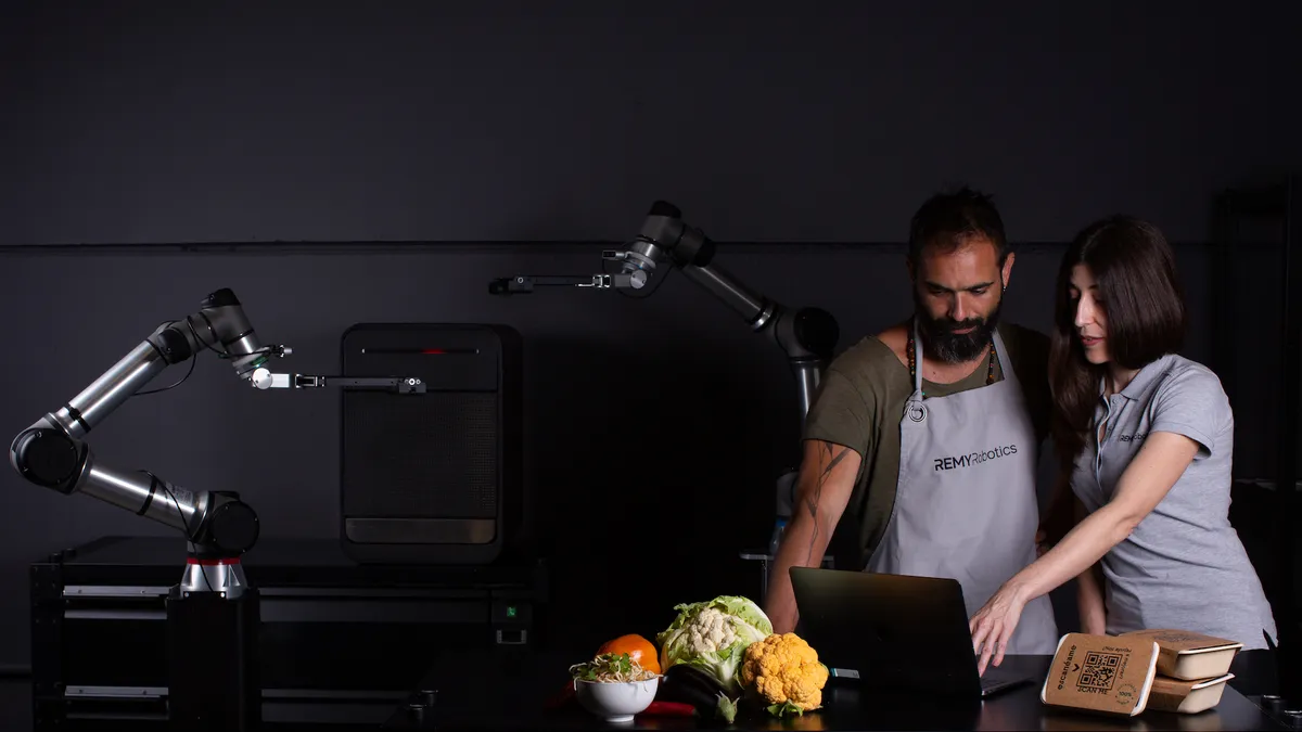 Man and woman looking into laptop inspecting food ingredient