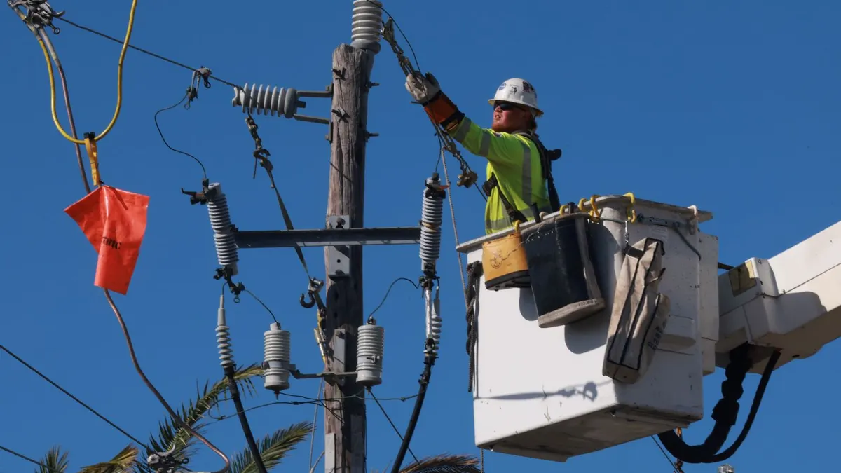 A lineman repairs power lines after Hurricane Milton passed through the area on October 12, 2024, in Englewood, Florida.