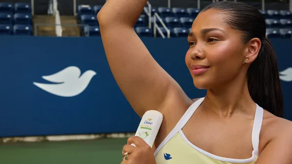 Woman applies Dove deodorant