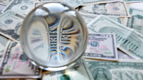 US dollar bill seen through a crystal ball. Creative concept, business, banking, taxes and finance