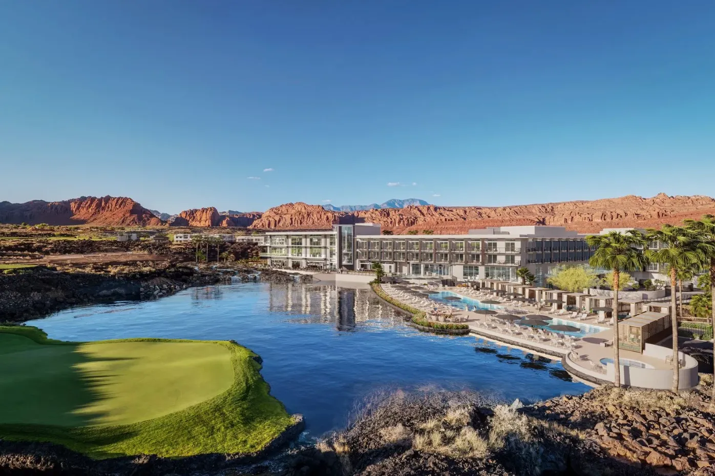 The Black Desert Resort behind a lake in the foreground and mountains in the background.