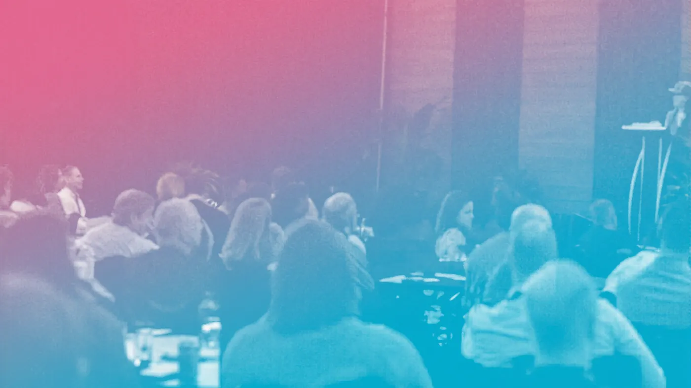 Image of poeple sitting at a conference