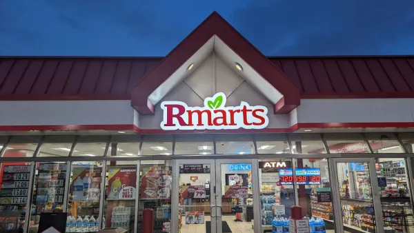 A photo of the exterior of a store at night. A sign on the building says Rmarts.