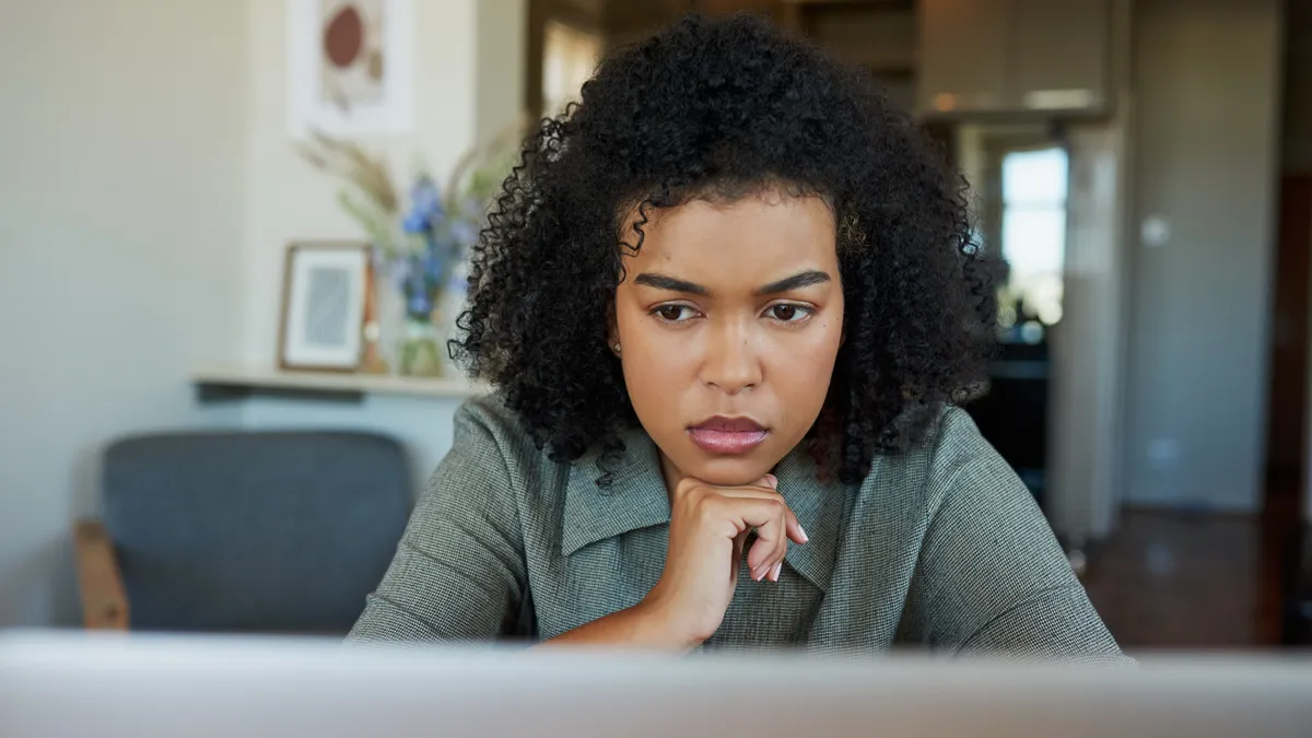 Shot of a young woman using a laptop at home