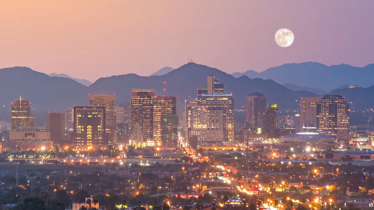 Sun setting above the Phoenix city skyline.