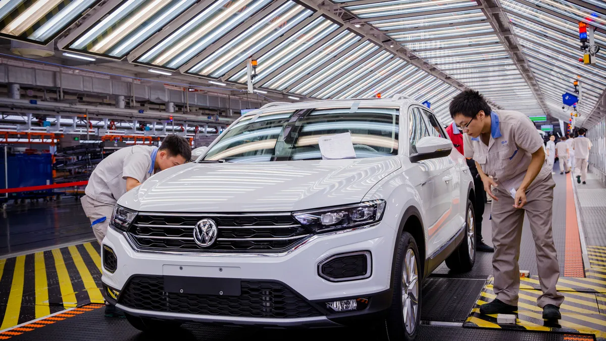 Workers assemble a vehicle at the FAW-Volkswagen factory in Foshan, China.