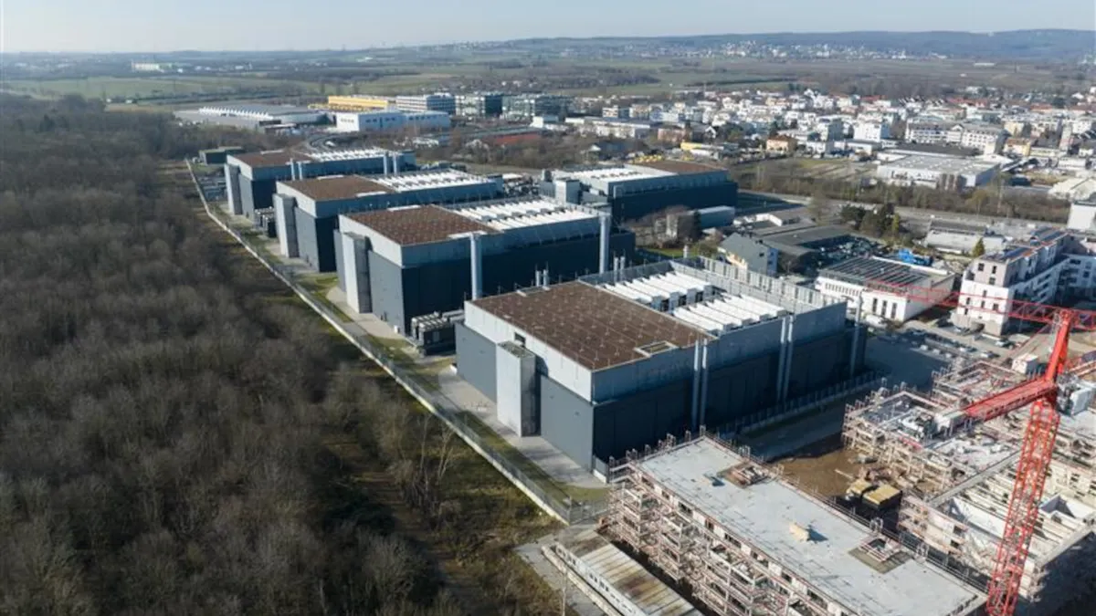An overhead shot of some building and a crane overtop of a building.