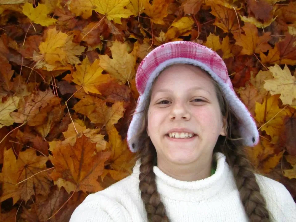 Mary Karth in leaves in autumn in Minnesota.