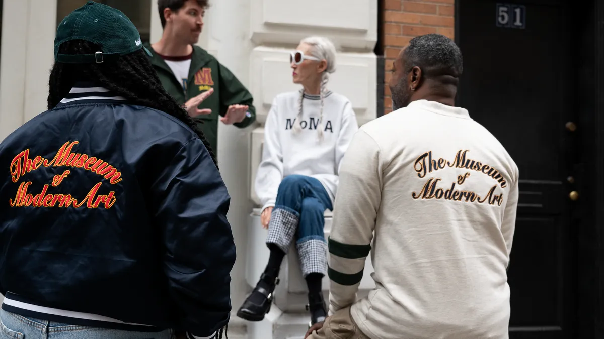 Models talk together wearing items from the Museum of Modern Art's collection with Champion.