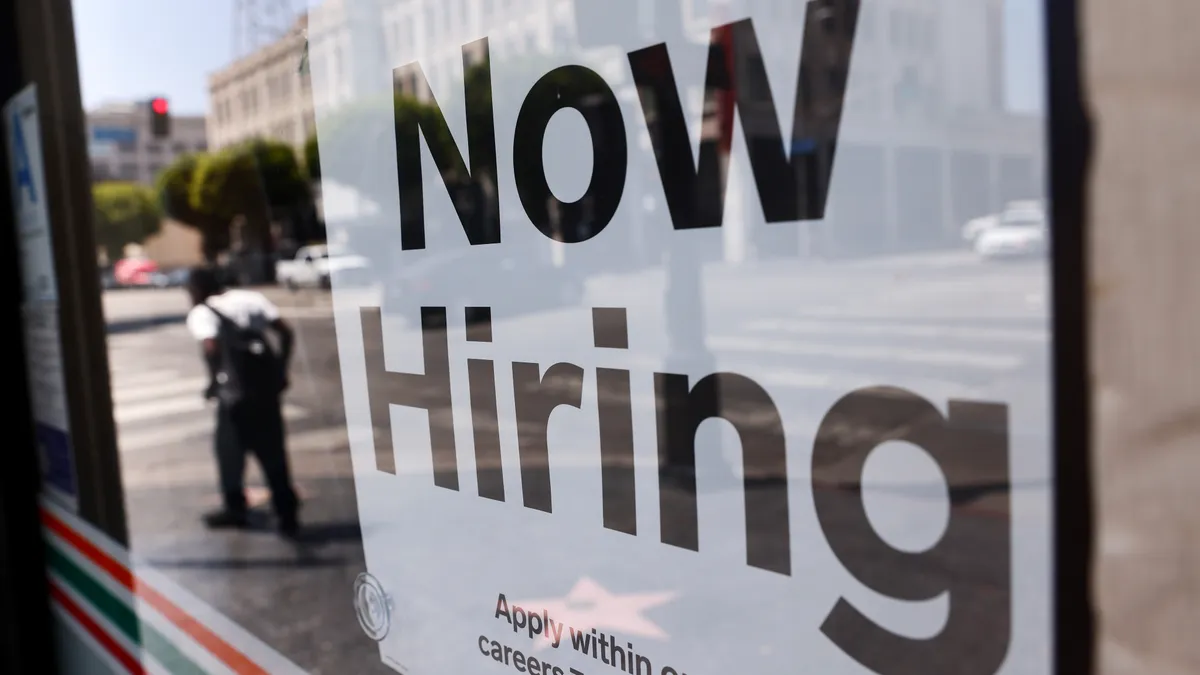 A photo of a "Help Wanted" sign in the window of a Los Angeles 7-Eleven.