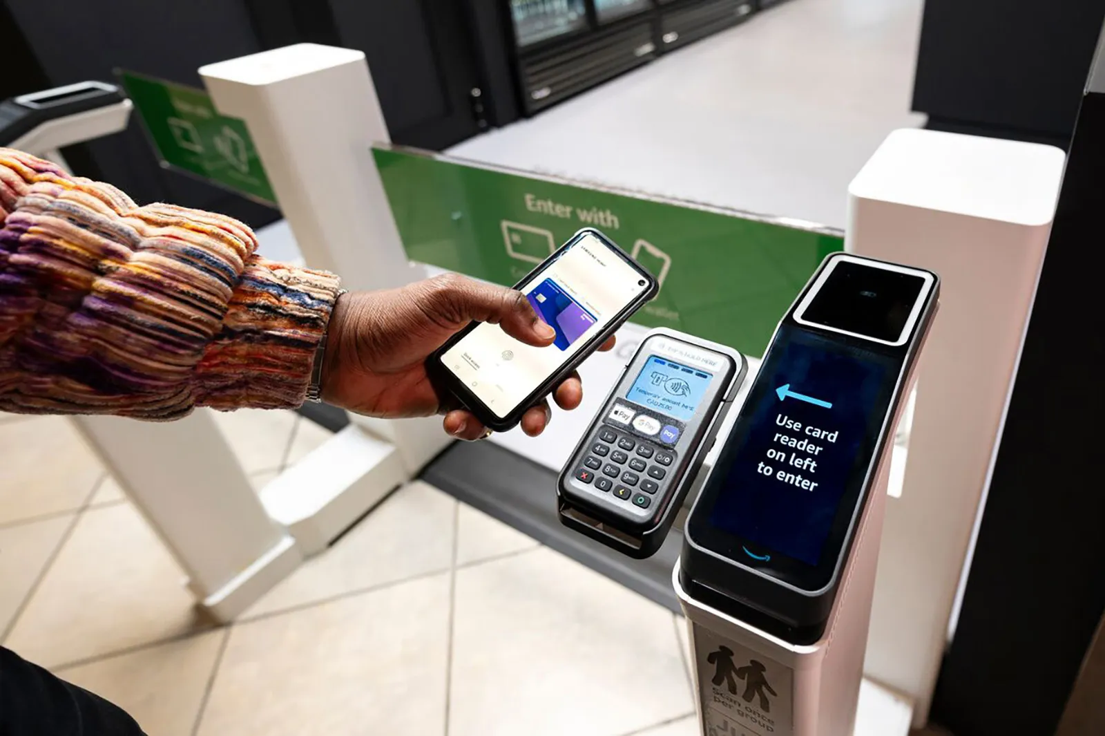 A customer scanning their phone at an Amazon Just Walk Out terminal