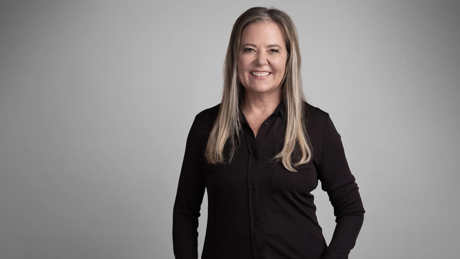 A headshot of Nike executive Heidi O'Neill against a grey background.