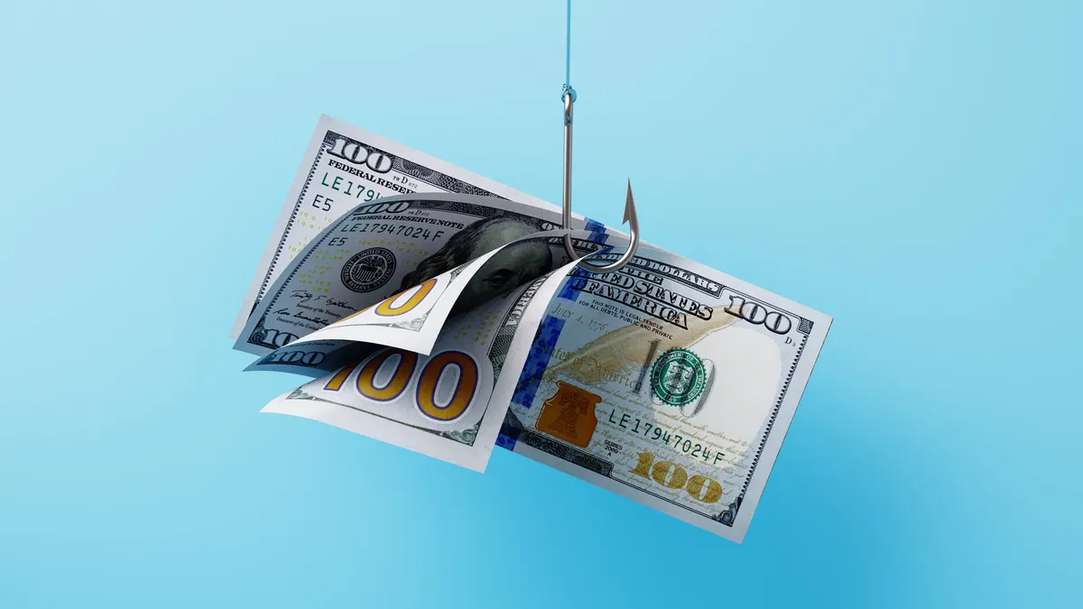 A Group Of American One Hundred Dollar Bills Hooked By A Fishing Hook